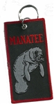 MANATEE KEY RING - Black Background with Manatee on it.